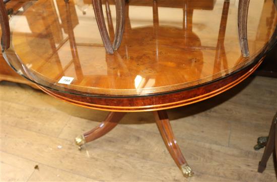 A modern yew breakfast table, with substantial circular plate glass top